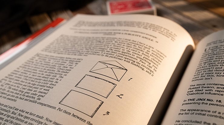 A magician's instructional book with diagrams on performing card tricks and illusions.