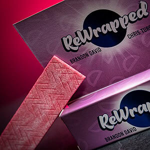 Bright pink and purple ReWrapped packaging with textured wrapping paper and bold logo design.