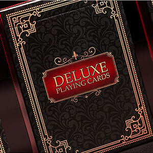Elegant black and gold Deluxe Playing Cards box with intricate design for premium card games.
