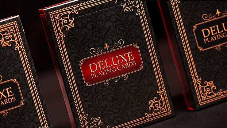 Elegant black and gold Deluxe Playing Cards box with intricate design for premium card games.