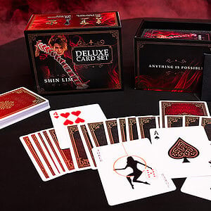 Deluxe magic card set with red and black themed playing cards and accessories.