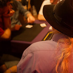 Magician Juan Tamariz performing card tricks at a magic shop event.
