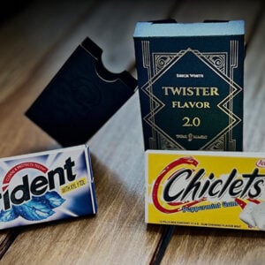 Trident peppermint gum and Chiclets chewing gum with Twister Flavor 2.0 box, magic-themed treats on wooden surface.