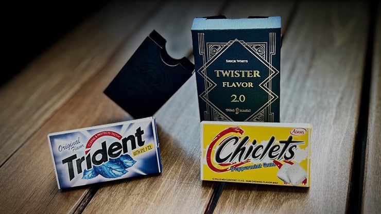 Trident peppermint gum and Chiclets chewing gum with Twister Flavor 2.0 box, magic-themed treats on wooden surface.