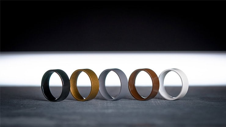 Black, gold, gray, brown, and white rings arranged in a row on a dark background.