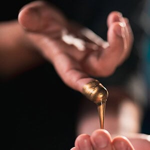 Hand holding a magic wand with sparkling effects for illusion shows.