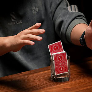 Mini e-ITR by K.Pen & TCC Magic performing a card trick with red T cards.