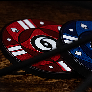 Colorful poker chips with a black string on a wooden surface.