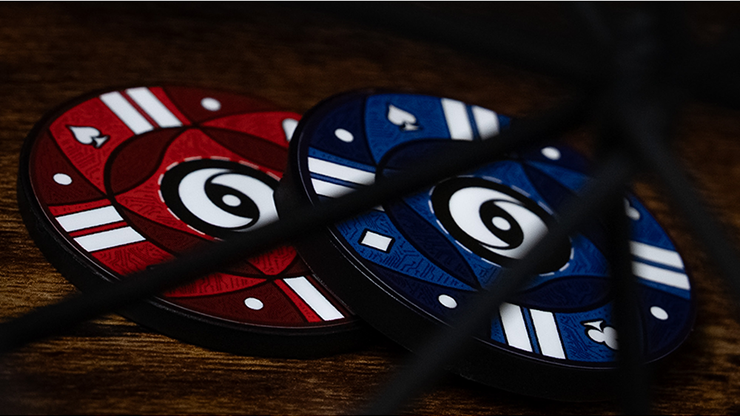 Colorful poker chips with a black string on a wooden surface.