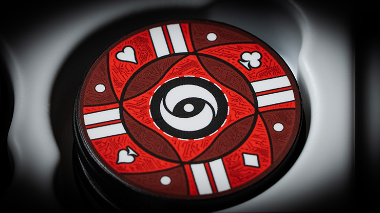 Red poker chip with black and white symbols and a spiral design in the center.