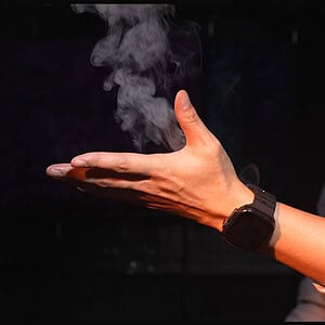 Close-up of a person demonstrating the AMOR WATCH modular magic system in action.