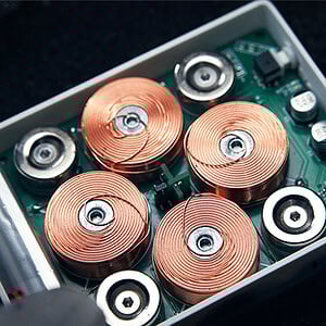 High-tech electronic components with copper coils inside a small circuit box for Leviti Deck by PITA.