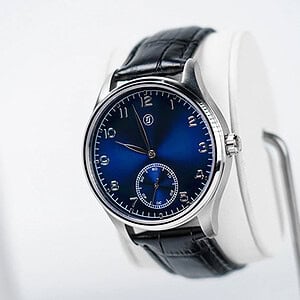 A colorful blue watch with a black leather strap, showcasing elegant design and craftsmanship.