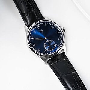 Elegant blue watch with black leather strap, modern design, and sleek appearance.