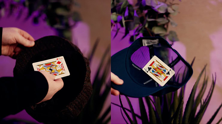 Close-up of a card being placed inside a black hat for a magic trick.