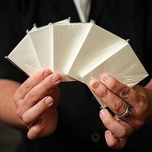 A colorful fan of playing cards held by a magician.