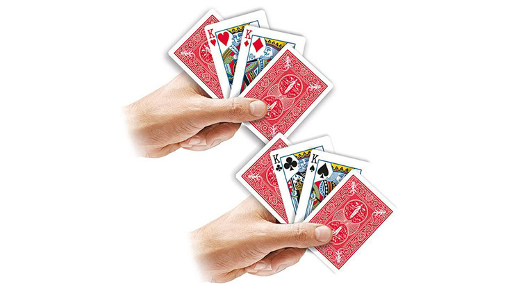 Close-up of hands holding a fan of playing cards for magic tricks.