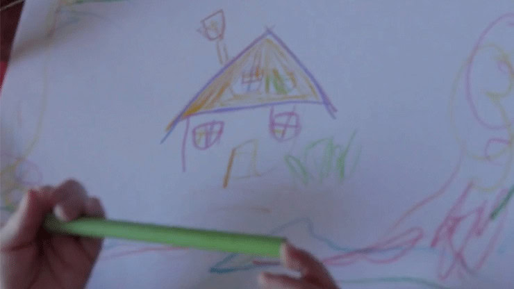 Child's colorful drawing of a house and a person with a green crayon.