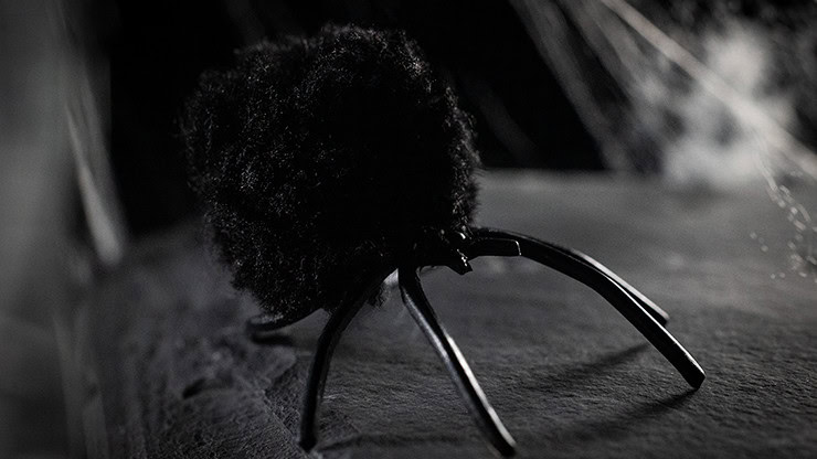 Close-up of a black spider prop used in magic illusions.