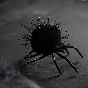 Close-up of a black spider prop used in magic illusions.