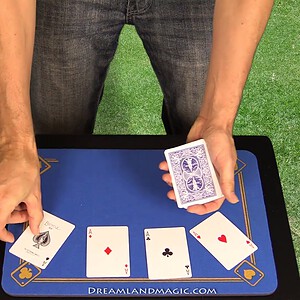 Magician performing card trick with four aces on a magic table.